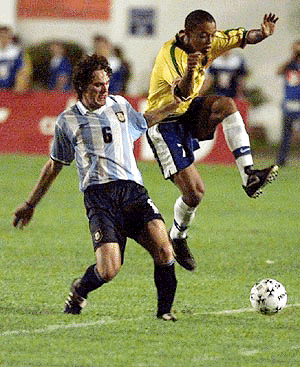 Gabriel Milito (left) of the Argentine soccer team, fights for the ball against Ronaldinho of the Brazilian soccer team during a game of the South American Olympic qualifying soccer tournament at the Cafe Stadium in the southern Brazilian city of Londrina on Wednesday