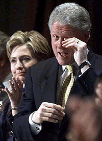 President Clinton wipes his eye after hearing the closing song at the congressional National Prayer Breakfast in Washington on Thursday. At left is first lady Hillary Rodham Clinton