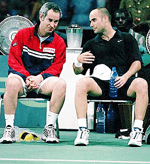 Andre Agassi (right) talks to John McEnroe, the non-playing US Davis Cup team captain during his match against Zimbabwe's Wayne Black at the Harare City Sports Centre on Friday. Agassi won in straight sets.  AP/PTI