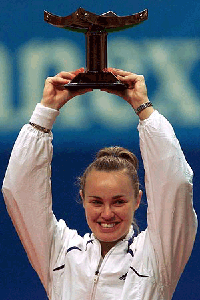 Switzerland's Martina Hingis holds her trophy aloft after winning of the Pan Pacific Open women's tennis tournament in Tokyo on Sunday