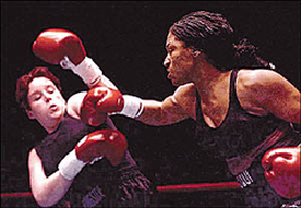 Jacqueline Frazier-Lyde (right) punches Teela Reese during the first round Sunday, in Scranton, Pa.