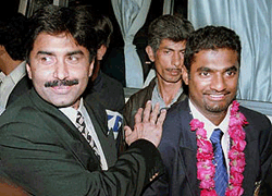 Javed Miandad, left, official of the Pakistani Cricket Board and former batsman of Pakistani cricket team, welcomes Sri Lankan bowler Muralitharan (right) upon the Sri Lankana cricket team's arrival at Karachi International Airport Monday morning