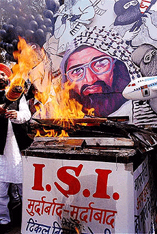 Activists of the Rajiv Gandhi Sadbhavana Manch burning a portrait of Maulana Mohd. Masood Azhar at Jantar Mantar in New Delhi on Monday, in protest against the Pakistan backed terrorist activities in India