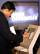 A visitor tries out an MTNL instant Internet connection terminal at "IT Asia 2000", in New Delhi.  AFP 