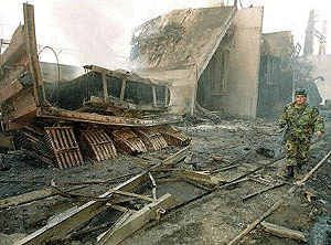 A Lebanese soldier walks past Jamhur power station hit by Israeli fighter planes