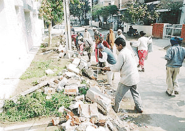 Labourers remove encroachments by residents in Sector 8 of Panchkula on Tuesday.