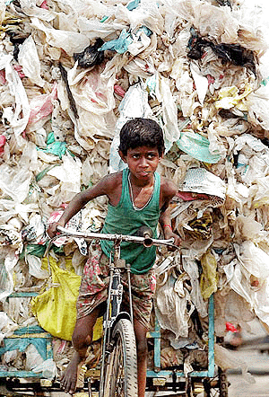 Ten-year-old Ravi Pradhan cycles a cartload of plastic bags for recycling in Calcutta on Sunday. Ravi contributes Rs 25 daily to his familys income by supplying plastic to the recycling indusry. Thousands of such poor people, mostly children, earn their living from plastic goods recycling in Calcutta
