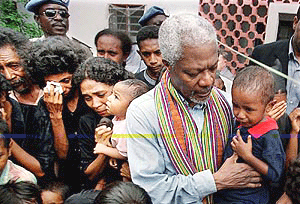 UN Secretary-General Kofi Annan comforts a crying baby