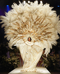 Spanish model Paola Dominguin models a white tunic with gold boardings and a feather plume during the Winter-Fall Pasarela Cibeles fashion week in Madrid, Spain, on Thursday. 