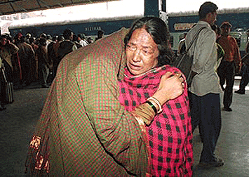 A passanger of ill fated Punjab Mail being console by her relative after she arrives by a special train in New Delhi railway station on Sunday morning