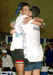 India number one P. Gopichand embraces doubles partner Vincent Lobo on clinching the Rubber against Thailand in New Delhi on Sunday