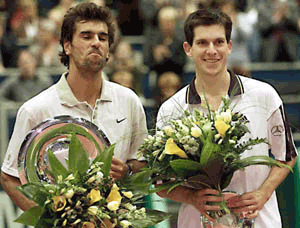 Cedric Pioline of France (left) grimaces during a trophy ceremony while Britain's Tim Henman smiles after the final match at the ABN AMRO tournament in Rotterdam on Sunday