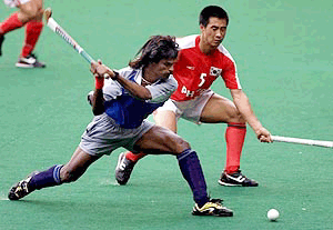 Dhanaraj Pillay of India (left) and Kim Jung Seon of South Korea battle for the ball during their match in the 10th Sultan Azlan Shah Cup hockey in Kuala Lumpur on Monday