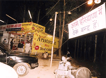 With the Haryana Government having closed liquor shops in the state due to the elections, liquor traders in the city have displayed banners near the Haryana-Chandigarh border to attract buyers to purchase their quota of liquor.  Tribune photo by Parvesh Chauhan