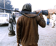 An armed supporter of a candidate carrying party symbol campaining in Betiya on Monday