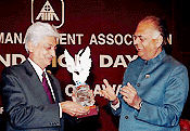 Deputy Chairman of Planning Commission K.C. Pant presenting JRD Tata corporate leadership award to the Chairman of Wipro Ltd, Mr Azim H. Premji, at the foundation day of the All-India Management Association in New Delhi on Monday 