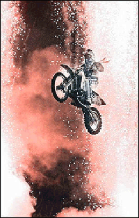 Amid fireworks, Robbie Knievil jumps a train at the Texas State Railroad Park in Palestine, Texas on Wednesday