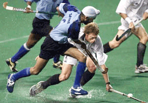 Baljit Singh Saini of India (left) controls the ball while Simon Towns of New Zealand follows during the 10th Sultan Azlan Shah Cup in Kuala Lumpur on Thursday. India lead 2-1 on the half time