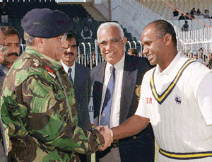 Gen. Pervez Musharraf (left) chief executive of Pakistan, greets Sanath Jayasuriya, captain of Sri Lankan cricket team at a Rawalpindi stadium on Saturday
