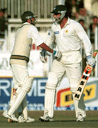 Younis Khan, (left) being greeted by Wasim Akram as he scored 100 against Sri Lanka, in Rawalpindi on Tuesday. 