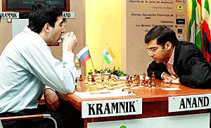 Vladimir Kramnik of Russia (left) takes a drink while his opponent, Viswanathan Anand of India ponders his move during the 2nd round of the Linares Grandmaster Chess Tournament, in Linares, southern Spain on Tuesday