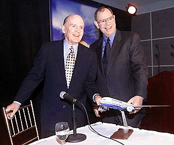 General Electric Chairman and CEO Jack Welch, left, and Boeing Chairman and CEO Phil Condit pose together after announcing the launch of two new longer-range models of the twin-engine 777, on Tuesday, in New York. This announcement moves the longer-range Boeing 777-200 and 300 airplanes into production with first deliveries beginning in September 2003. 
