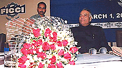 Union Finance Minister Yashwant Sinha sits behind a bouquet of flowers presented to him by the FICCI president in New Delhi on Wednesday. The Finance Minister addressed the Iindustrialists on the implications of the Union Budget 2000.