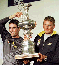Team New Zealand's skipper Russell Coutts (left) and Dean Barker proudly displays the Americas Cup after they defeated Italy's Prada 5-0 in the Americas Cup in Auckland, on Thursday