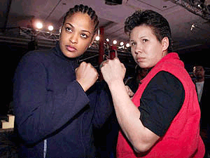 Boxers Laila Ali , of Los Angeles, Calif. and Crystal "Brave Heart" Arcand, (right) pose at a news conference in Windsor, Ont., Canada on Monday