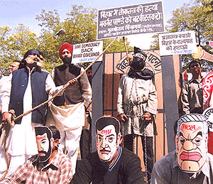 Activist of the All-India Bhrashtachar Virodhi Morcha demonstrate near Parliament House to demand the sacking of the Bihar Governer. They also staged a play simultaneously to depict democracy being hung to death by the Governor