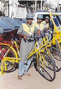 On the eve of the International Women's Day, women in uniform are ready to go on their job of garbage collection in Chennai on Tuesday. Solid waste management, privatised in some divisions of the Chennai city recently, has been entrusted to a Singapore firm.  PTI photo