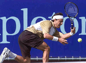 Francisco Clavet, of Spain, returns a ball against Andre Agassi during the Franklin Templeton Tennis Classic at the Scottsdale Princess Resort in Scottsdale, Ariz., on Thursday