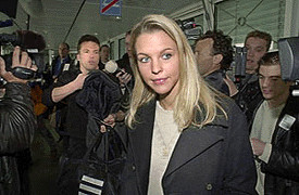 German soccer player Lothar Matthaeus (L, background) with his girlfriend Maren Mueller-Wohlfahrt (C) is surrounded by journalists and cameramen as he leaves the check-in area of Munich airport on Friday