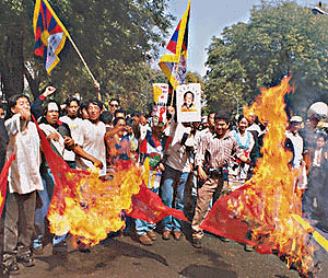 Tibetans burn the Chinese flag during a demonstration near Jantar Mantar in New Delhi on Friday on the occasion of the 41st anniversary of the Tibetan National Uprising Day