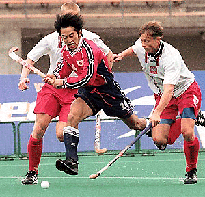  OSAKA : Naoya Iwadate, left, of Japan and Tomasz Szmidt, right, of Poland vie for the ball during the second half of their match in the Sydney Olympic qualifying at Nagai Sports Complex in Osaka, western Japan, Saturday, March 11, 2000. Japan won the match 2-0. AP/PTI