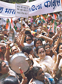 Women Congress activists beating a thali with a rolling pin to focus attention on rising prices in New Delhi on Tuesday