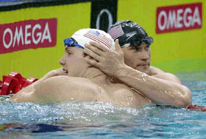 Neil Scott Walker (left) of the United States , receives a hug from teammate Lenny Krayzelburg after winning the 50m backstroke final of the 5th World Swimming Championships (25m) in Athens on Thursday. Walker set a world record in the 50m backstroke heat and semi final earlier in the day