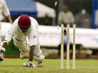Chris Gayle of the West Indies is run out for 33 off the bowling of Mpumelelo Mbangwa of Zimbabwe during the first day of the first test match at the Queen's Park Oval cricket club in Port-of-Spain, Trinidad on Thursday