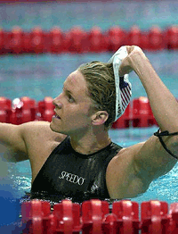 Jenny Beth Thompson from the United States pulls off her cap after she won the 100m butterfly semi- final of the 5th World Shortcourse Swimming Championships in Athens on Saturday