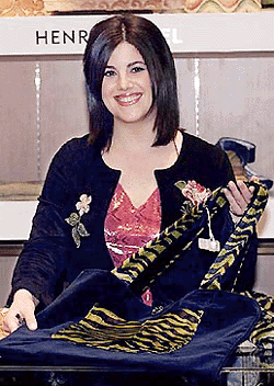    NEW YORK : Monica Lewinsky shows off one of the handbags from her spring collection at a New York department store,  on Wednesday. Lewinsky has put an "Inc." after her name, and is selling a line of high-end handbags on the Internet and at one of New York's toniest designer shops. She's also a spokeswoman for the weight-loss company Jenny Craig. AP/PTI