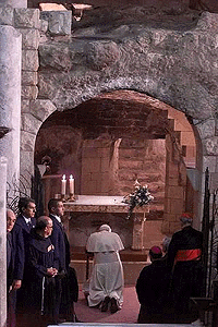 Pope John Paul II prays at the Grotto of the Basilica of the Annunciation in Nazareth on Saturday. The Grotto is the place where tradition maintains that the Virgin Mary first learned she was pregnant with the baby Jesus