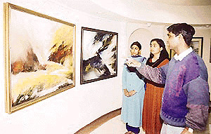 Bheem Malhotra shows his work to visitors at IndusInd Art Gallery, Sector 8, Chandigarh, on Monday. 