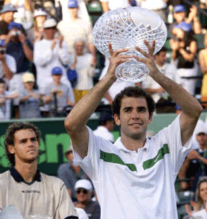 Pete Sampras holds up his trophy as Gustavo Kuerten of Brazil, looks on, after Sampras won the Ericsson Open in Key Biscayne on Sunday