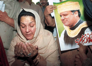 Kulsoom Nawaz, wife of Nawaz Sharif, deposed prime minister of Pakistan prays to God for the safety of her husband, in public meeting in Lahore on Sunday. Sharif and six others have been charged with hijacking, terrorism, kidnapping and attempted murder. The court will announce the verdict on April 6, 2000 in Karachi