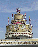 A replica of a giant cake sits on top of old airpoty tower which is bring used by the Singapore Peoples Association on Monday