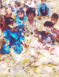 A group of freed child workers play with dry leaves while waiting under a tree for their leaders to arrive to lead their march in New Delhi on Monday to commemorate the global campaign to put every child in school