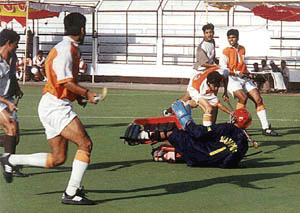 Indian Airlines striker Brozen Singh ditches Western Railway, Mumbai goalkeeper Sanjay Rathi to hit a goal in the semifinal to the 62nd All India Obedulla Khan Gold Cup Hockey tournament in Bhopal on Tuesday