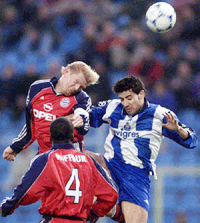 Stefan Effenberg (left) of FC Bayern Munich and Capucho of FC Oporto challenge for the ball during their first leg match in the Champions League quarter final in Oporto, Portugal, on Tuesday