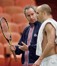 United States Davis Cup team captain John McEnroe (left) talks with Andre Agassi during practice on Wednesday, at the Great Western Forum in Inglewood, Calif. The United States will take on the Czech Republic in the 2000 Davis Cup quarterfinals starting Friday