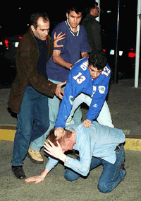Turkish soccer fans beat an unidentified English soccer fan in downtown Istanbul on Wednesday, a day before the UEFA Cup semifinal match between Galatasaray and Leeds United